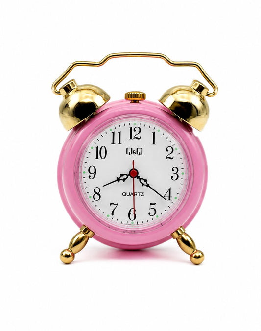 Sveglia Q&Q Quartz rosa con campane e piedini dorati su sfondo bianco